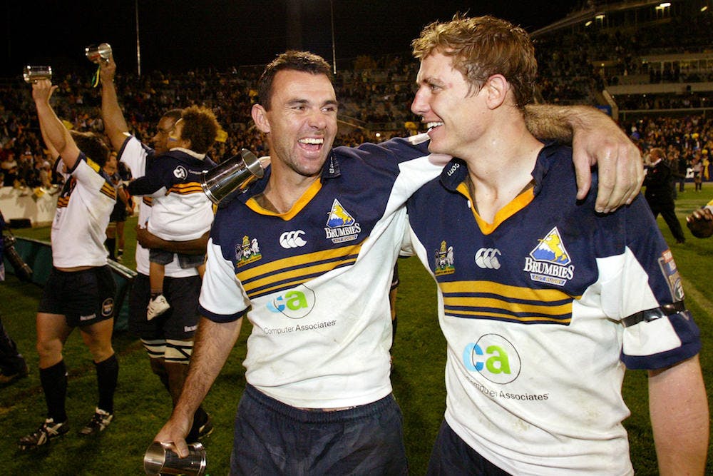 Stephen Larkham and Joe Roff celebrate their Super Rugby title in 2001. Photo: AFP