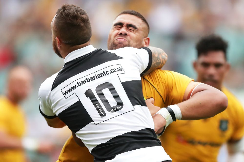 Quade Cooper tackles Lukhan Tui in the Barbarians-Wallabies clash of 2017. Photo: Getty Images