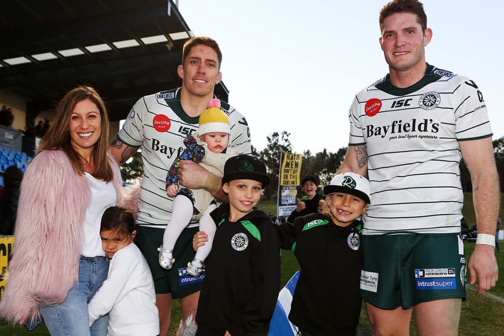 The Holmes brothers with Luke's wife Mel and their kids. Photo: Karen Watson