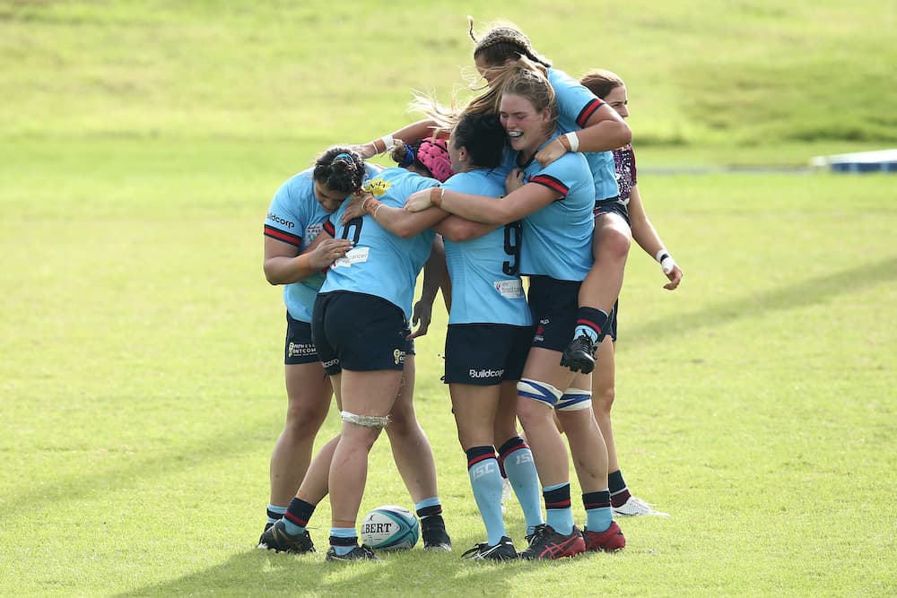 Piper Duck of the Waratahs celebrates with teammates after scoring a try during the round six Super W match between the NSW Waratahs and the Queensland Reds at Eric Tweedale Oval. Photo: Getty Images