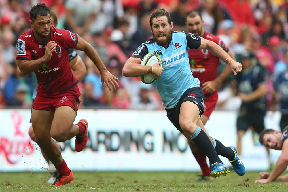 Bernard Foley skips away from Karmichael Hunt. Photo: Getty Images
