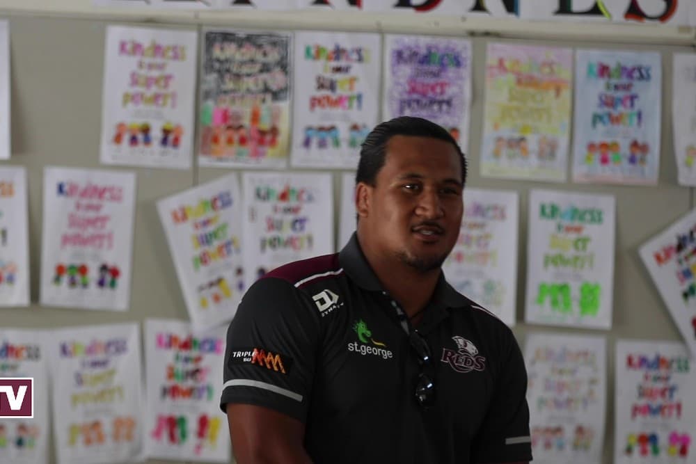 Brandon Paenga-Amosa talks to students at a school during the Reds to Regions tour. Photo: QRU Media