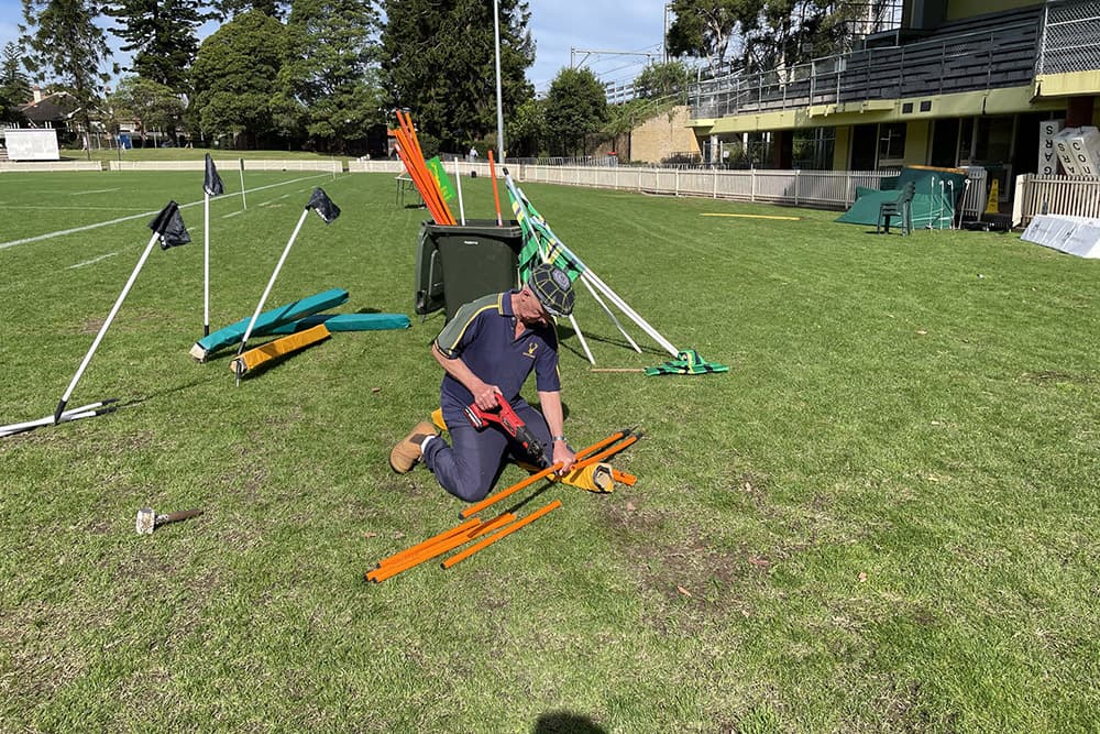 Beez fixing the broken corner posts at Chatswood Oval. Photo: Gordon Rugby