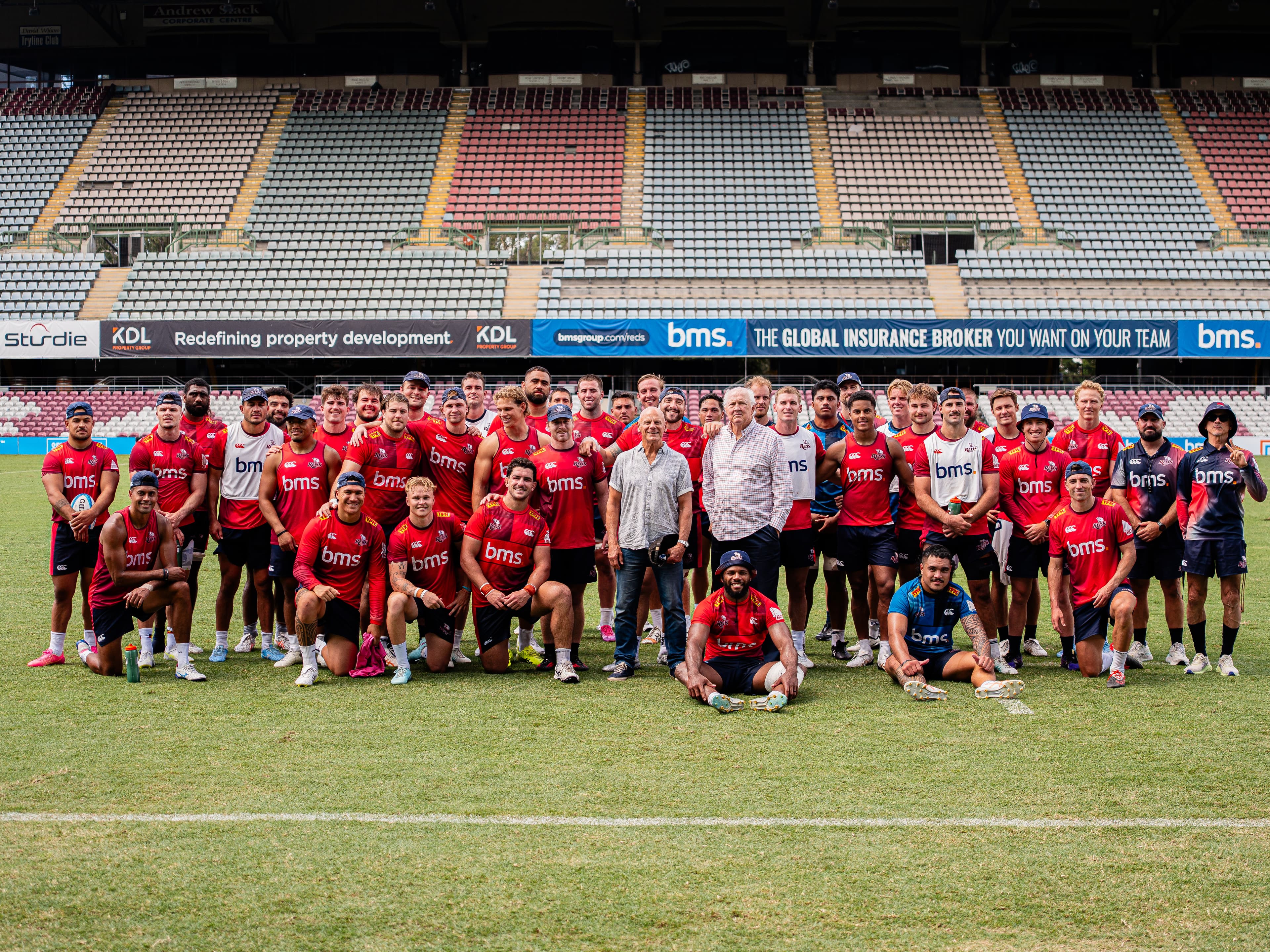 1976 Queensland team members (at centre) Greg Shambrook (left) and David Dunworth meet the Reds team at training at Ballymore