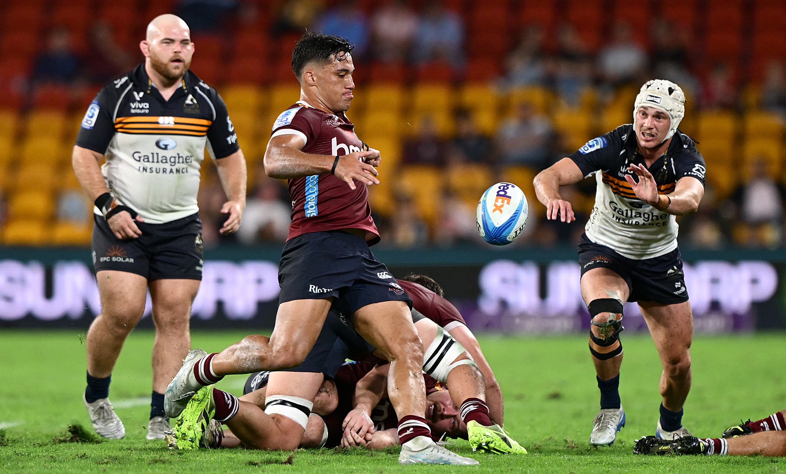 Reds halfback Kalani Thomas is all concentration as he prepares to box kick against the Brumbies. Photo: Bradley Kanaris, Getty Images
