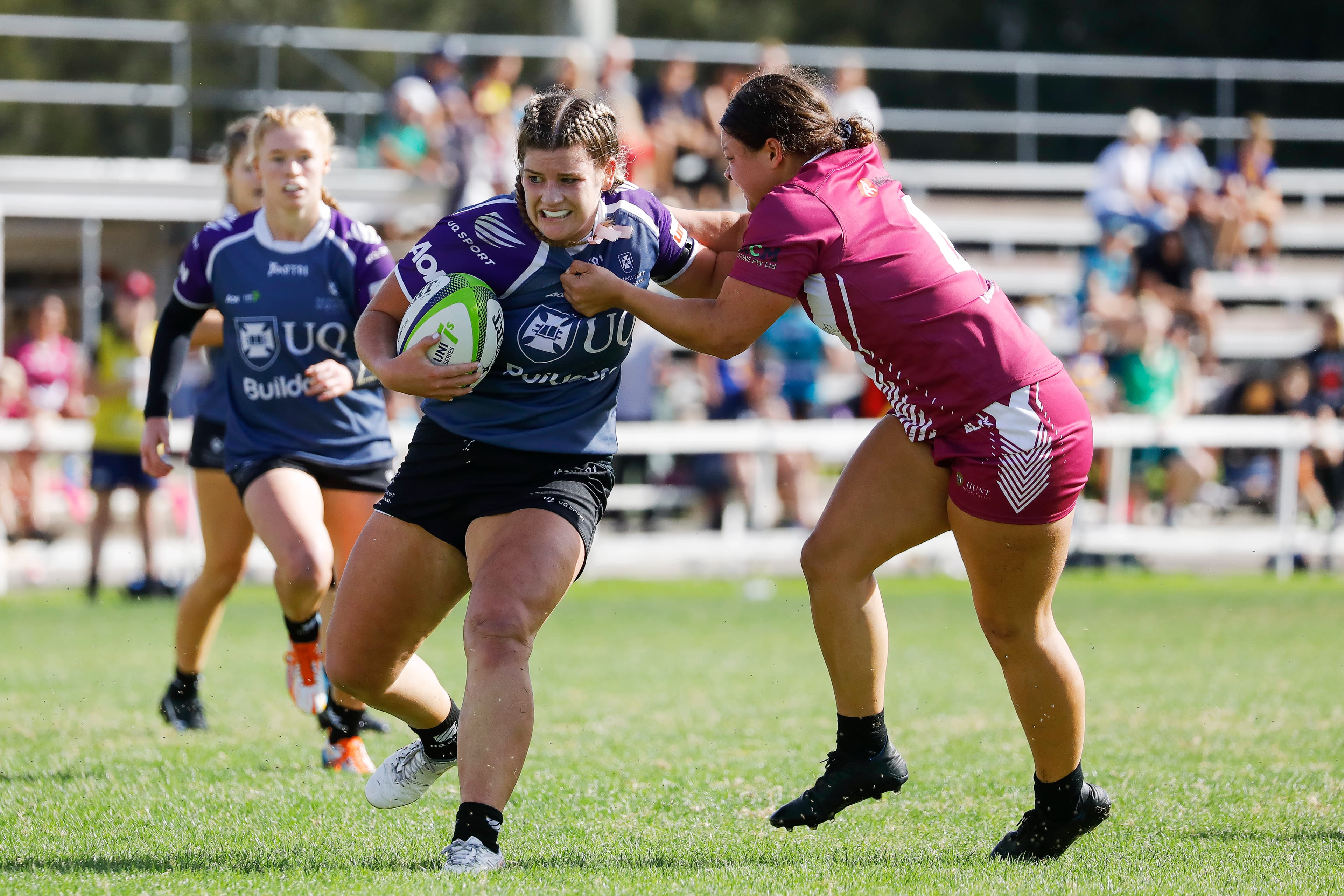 UQ's Isabella Nasser shrugs off a Newcastle Uni player. | Photo: Karen Watson