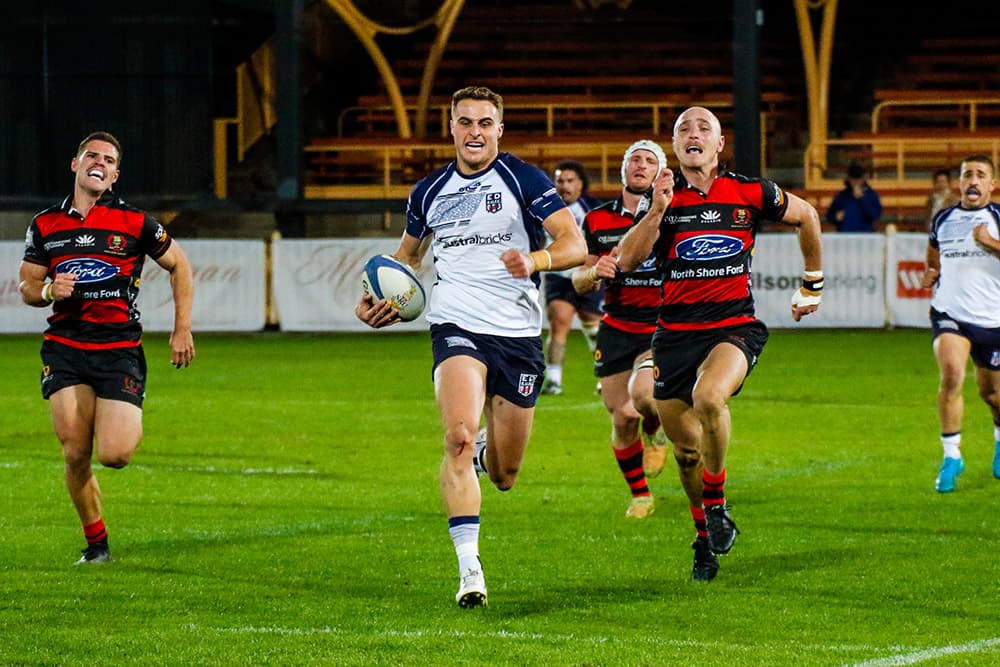 James Turner runs down Harry Wilson to stop a certain try. Photo: Serge Gonzalez 