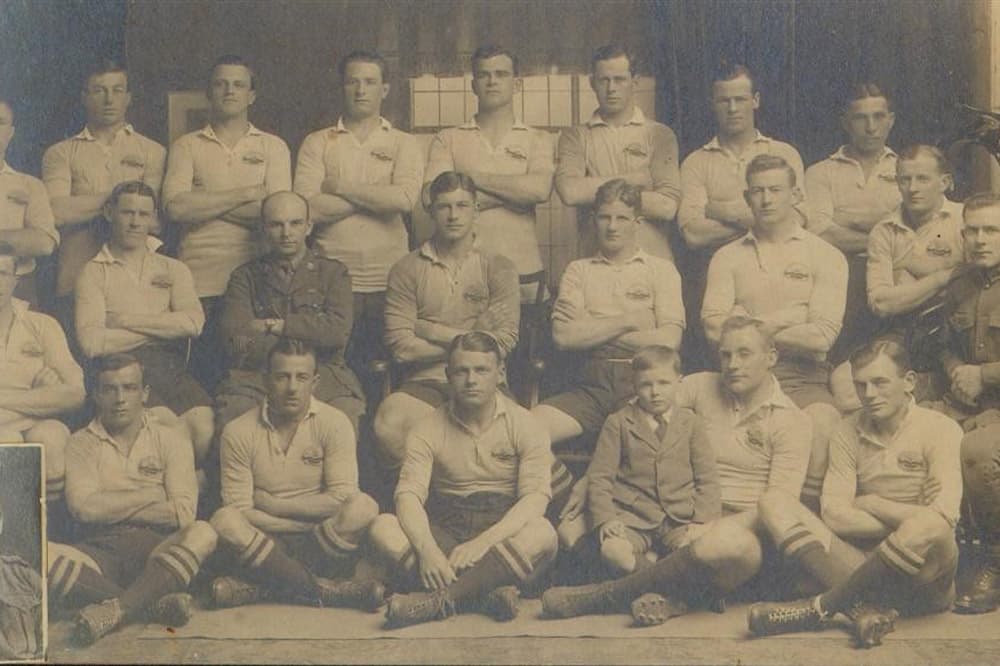 Australian AIF team in 1919, with Dan Carroll pictured in the front row with his son on his knee. Carroll paid his own fare to London to play in the Kings Cup to celebrate the WWI victory. Photo: ARU Archive.
