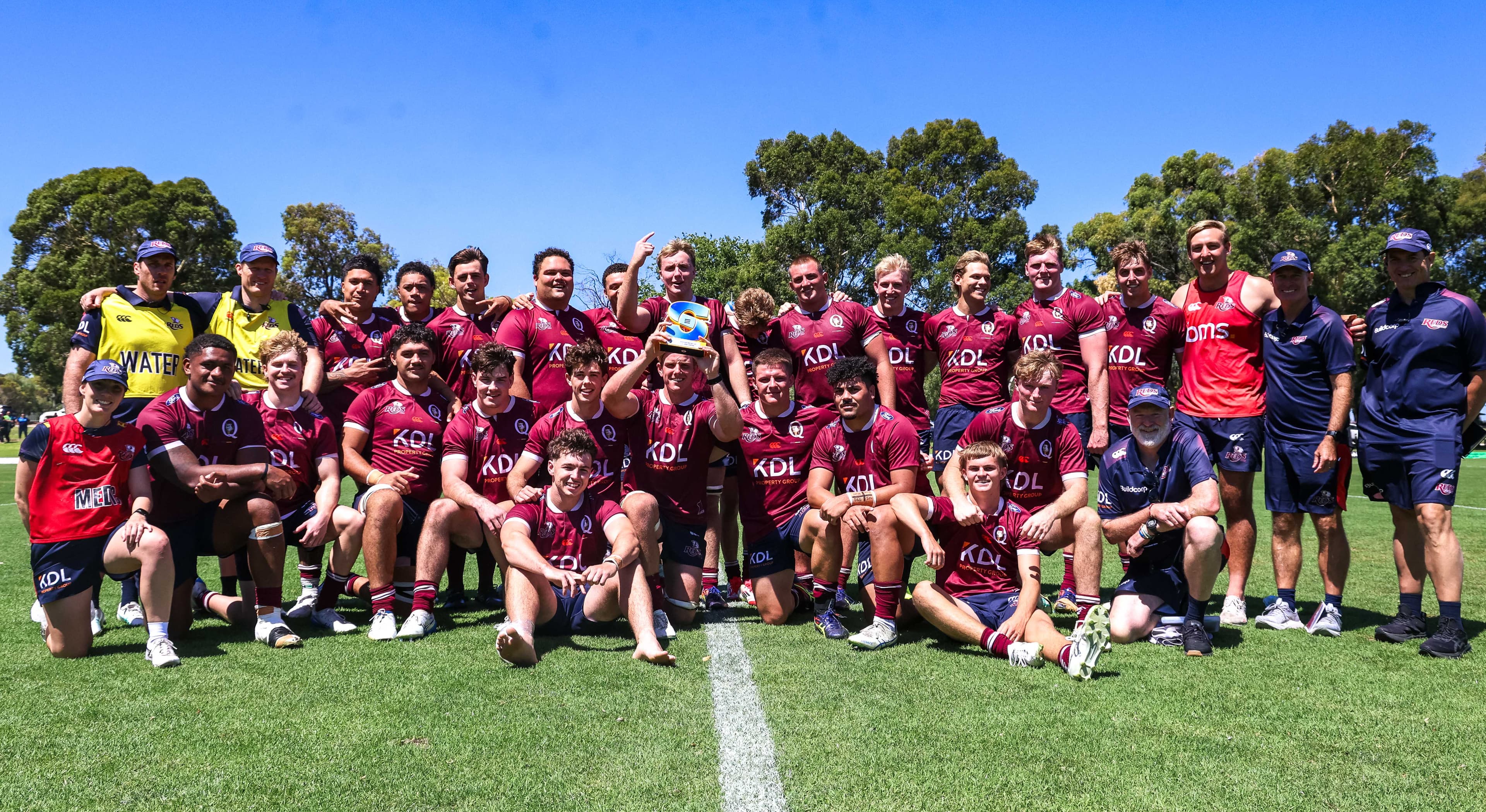 Trophy high...the Reds celebrate their Super Rugby Next Gen series win in Perth. Photo: Adam Crane