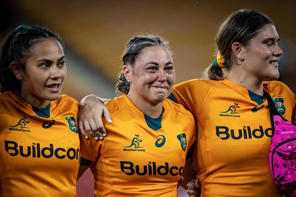 Madi Schuck (centre) lets the emotions flow during the singing of the national anthem before her Wallaroos debut against Fijiana. Photo: Brendan Hertel  