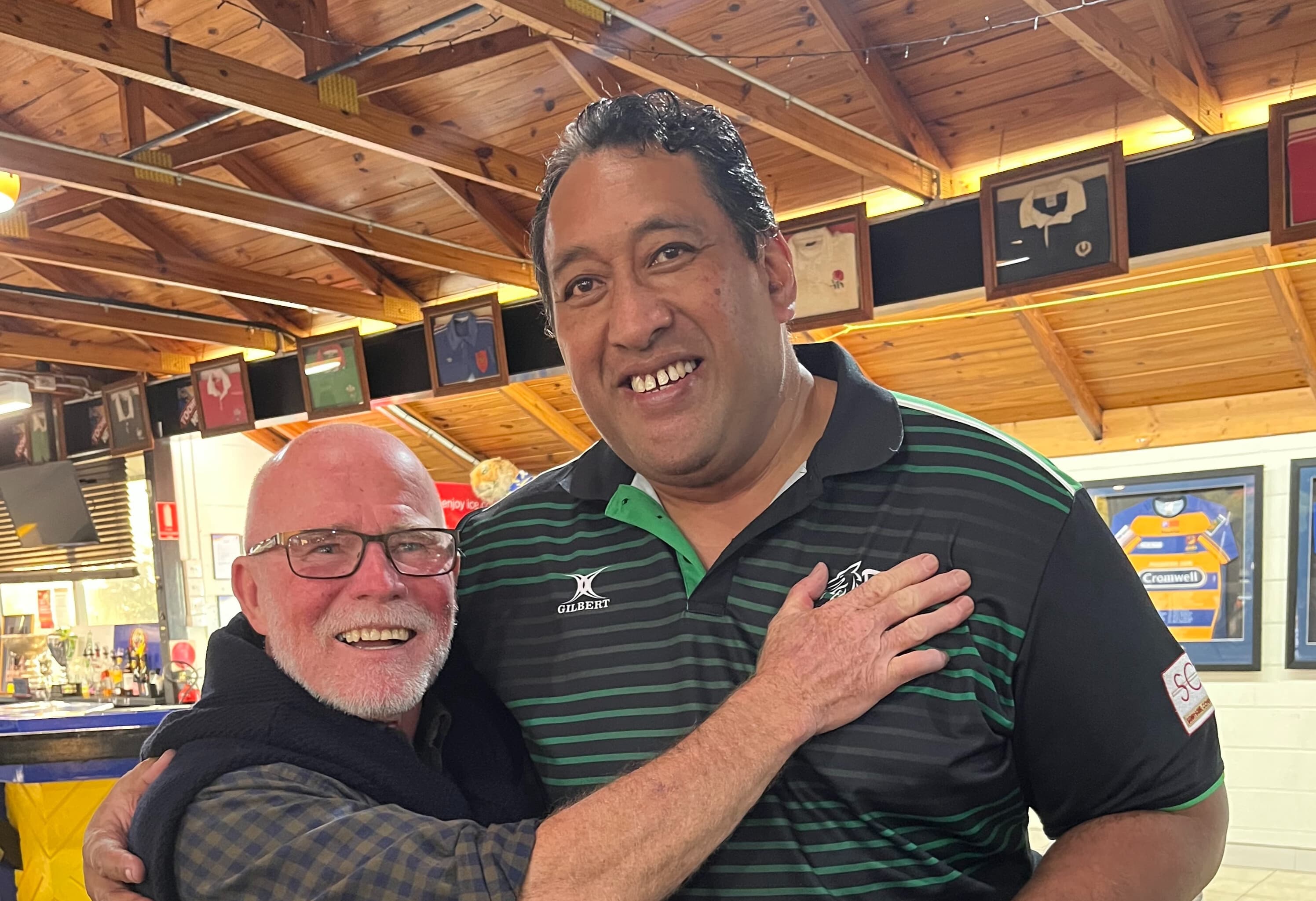 Grant Batty (left) catching up with Easts' 1997 premiership forward Salafai Sala at Bottomley Park in 2022 