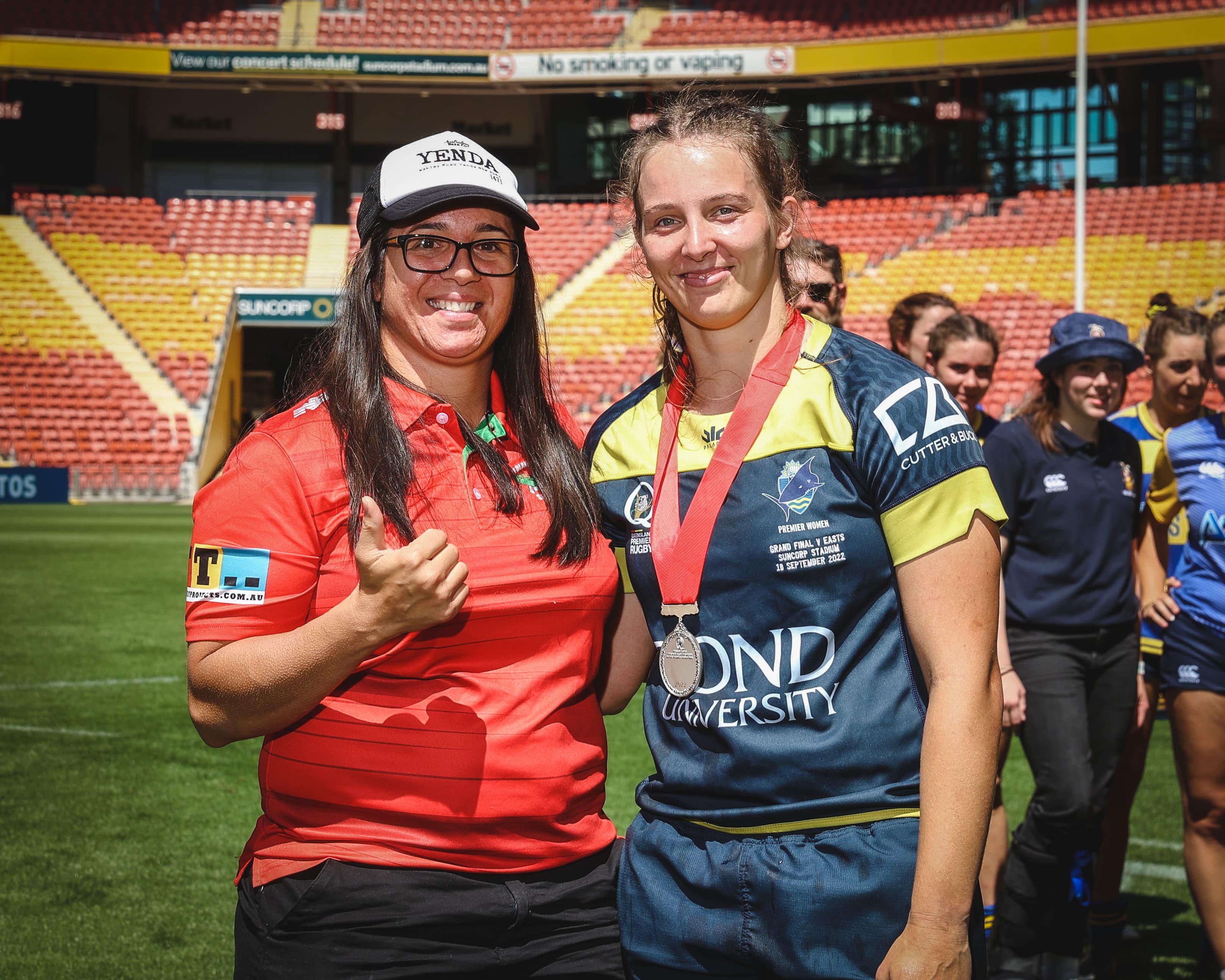 Bond's Mel Wilks (right) receiving the Cheyenne Campbell Medal from the former Wallaroo herself after the Brisbane women's grand final last year. Photo: Brendan Hertel, QRU