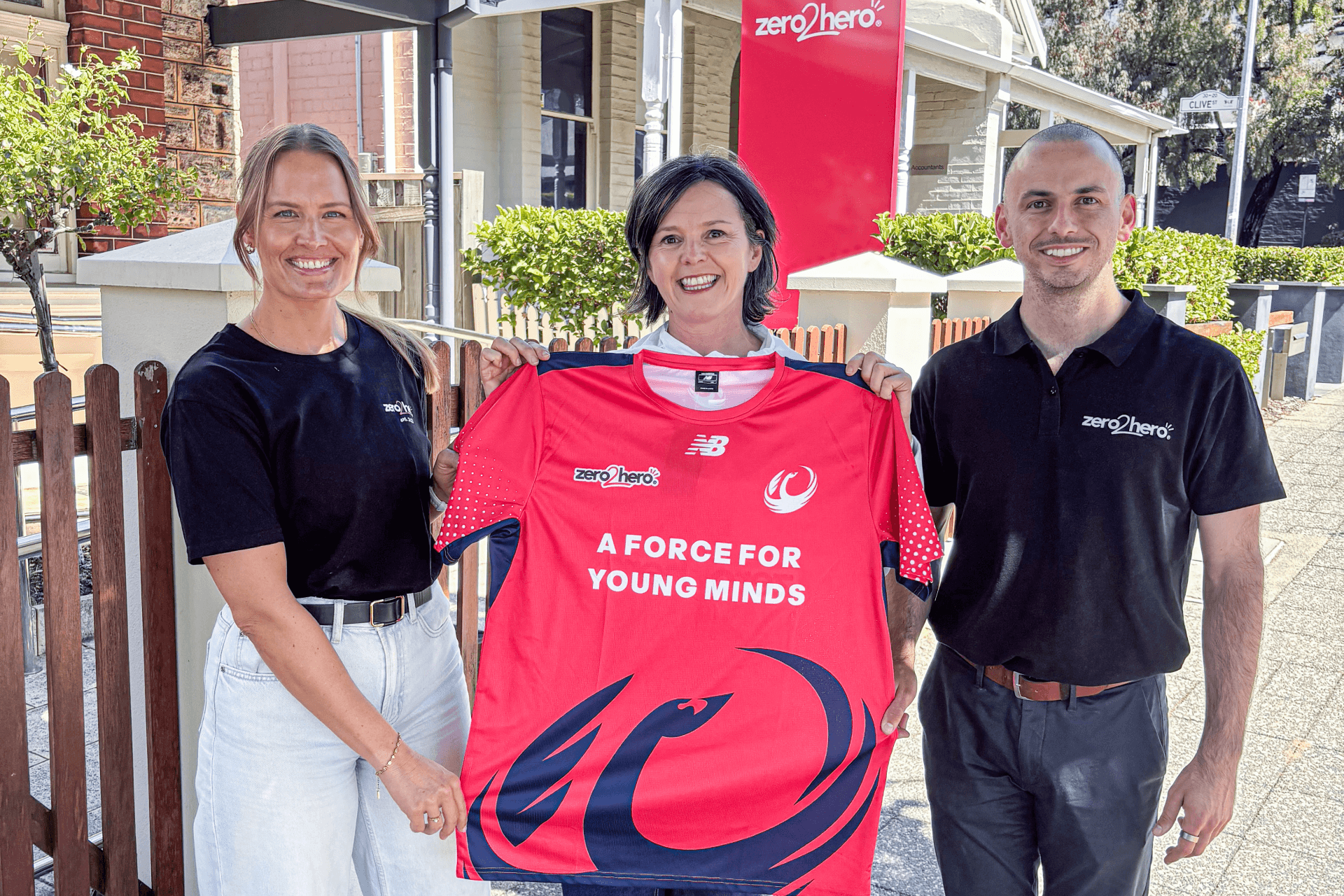 zero2hero Events Manager Amy Felton, Western Force CEO Niamh O'Connor and zero2hero Partnership & Fundraising Manager Oscar Wharton holding the Force's warm-up tee