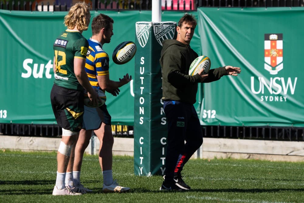 Andrew Johns working with halves Bernard Foley and Carter Gordon. Photo: Julius Dimataga/RA Media