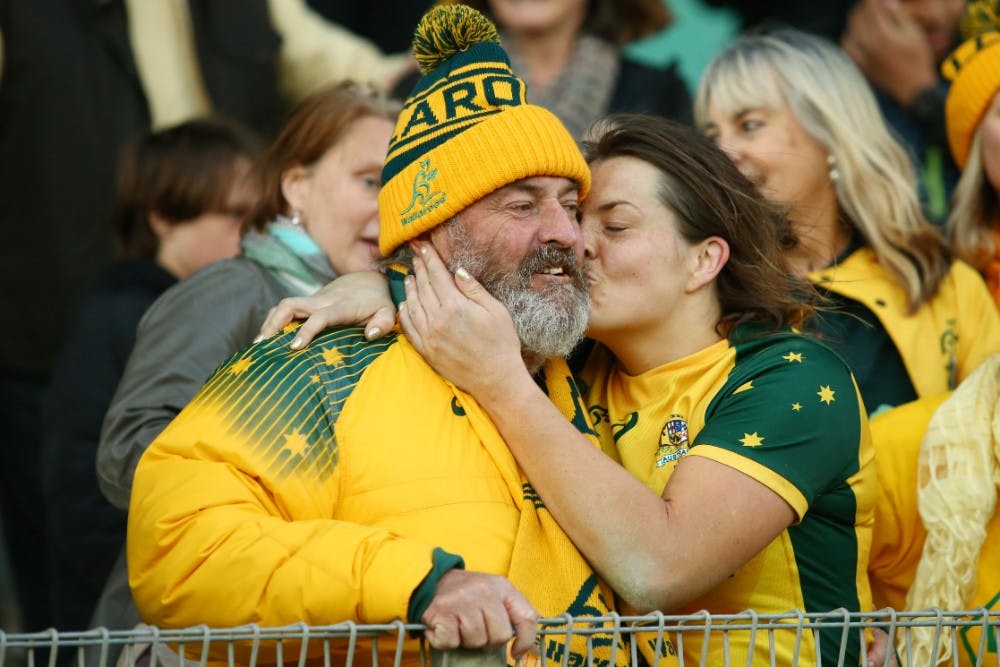 Grace Hamilton embraces her father after leading the Wallaroos to a Test win over Japan. Photo: Getty Images