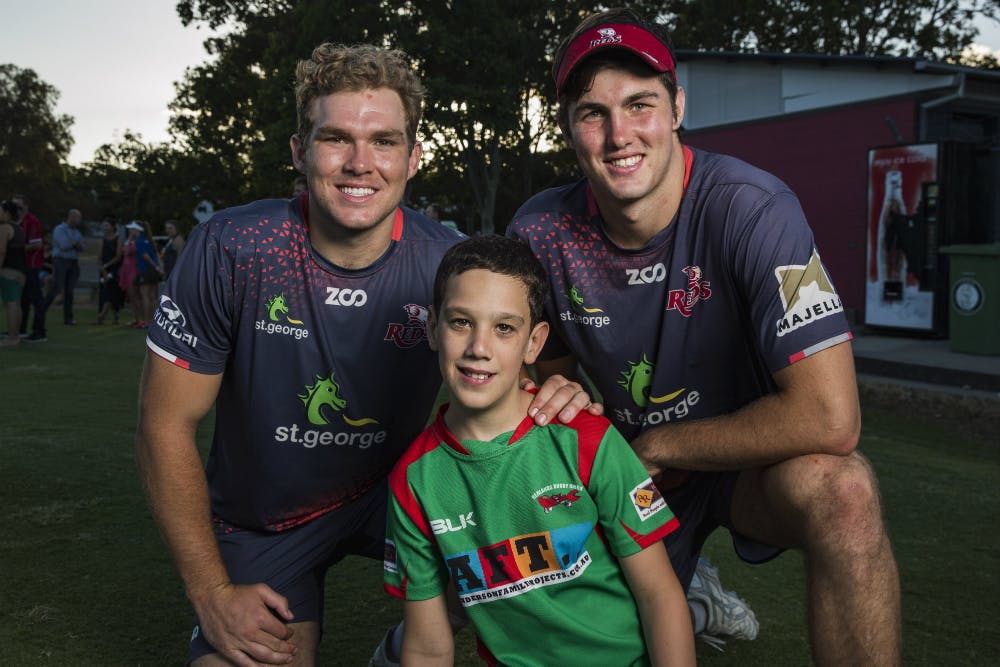 Angus Scott-Young and Liam Wright smile for the camera with a young Queensland fan. Photo: QRU Media/Brendan Hertel