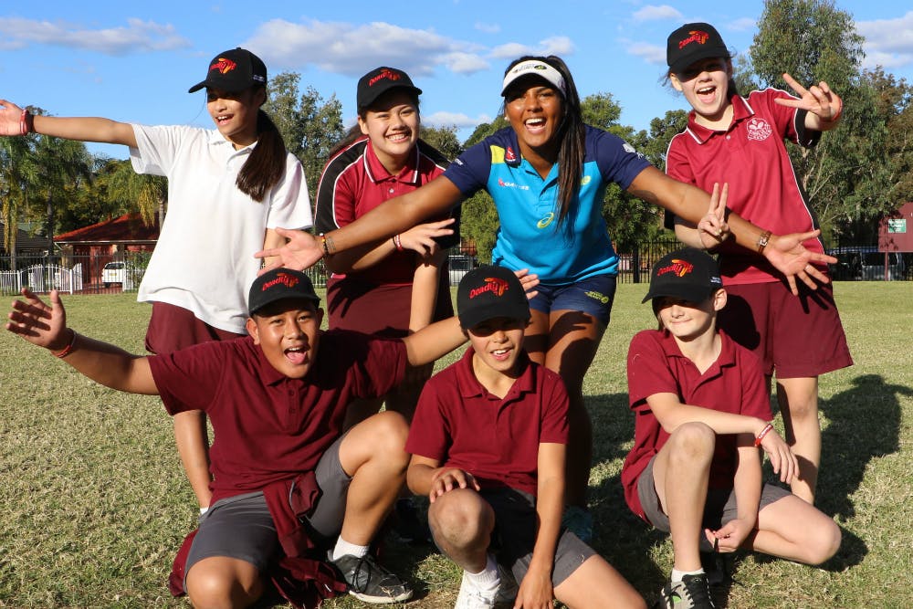 Mahalia Murphy smiles for the camera with some Deadly 7s participants. Photo: ARU Media
