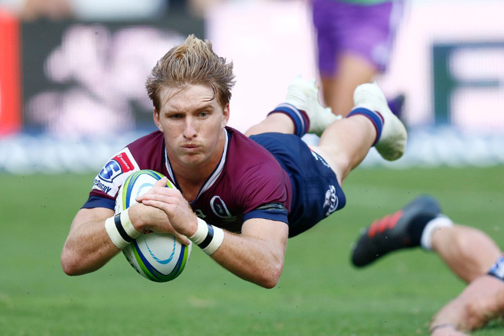 Tate McDermott scores a try to help the Reds to a win against the Sharks in Durban. Photo: AFP