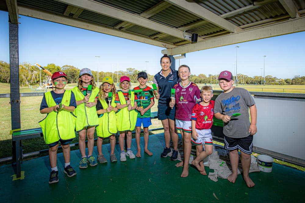 Wallaroos captain Shannon Parry finds a ready team of Redlands juniors with paintbrushes for the club makeover. Photo: Brendan Hertel, QRU
