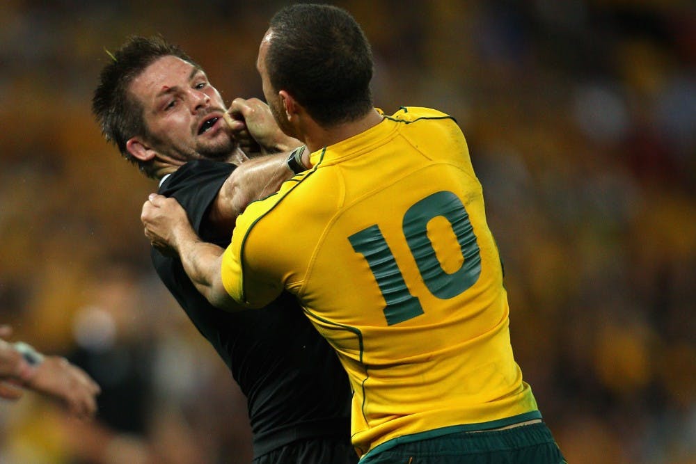 Quade Cooper takes on Richie McCaw in the 2011 World Cup, after kneeing the All Blacks captain in the head in the Bledisloe series earlier in the season. Photo: Getty Images